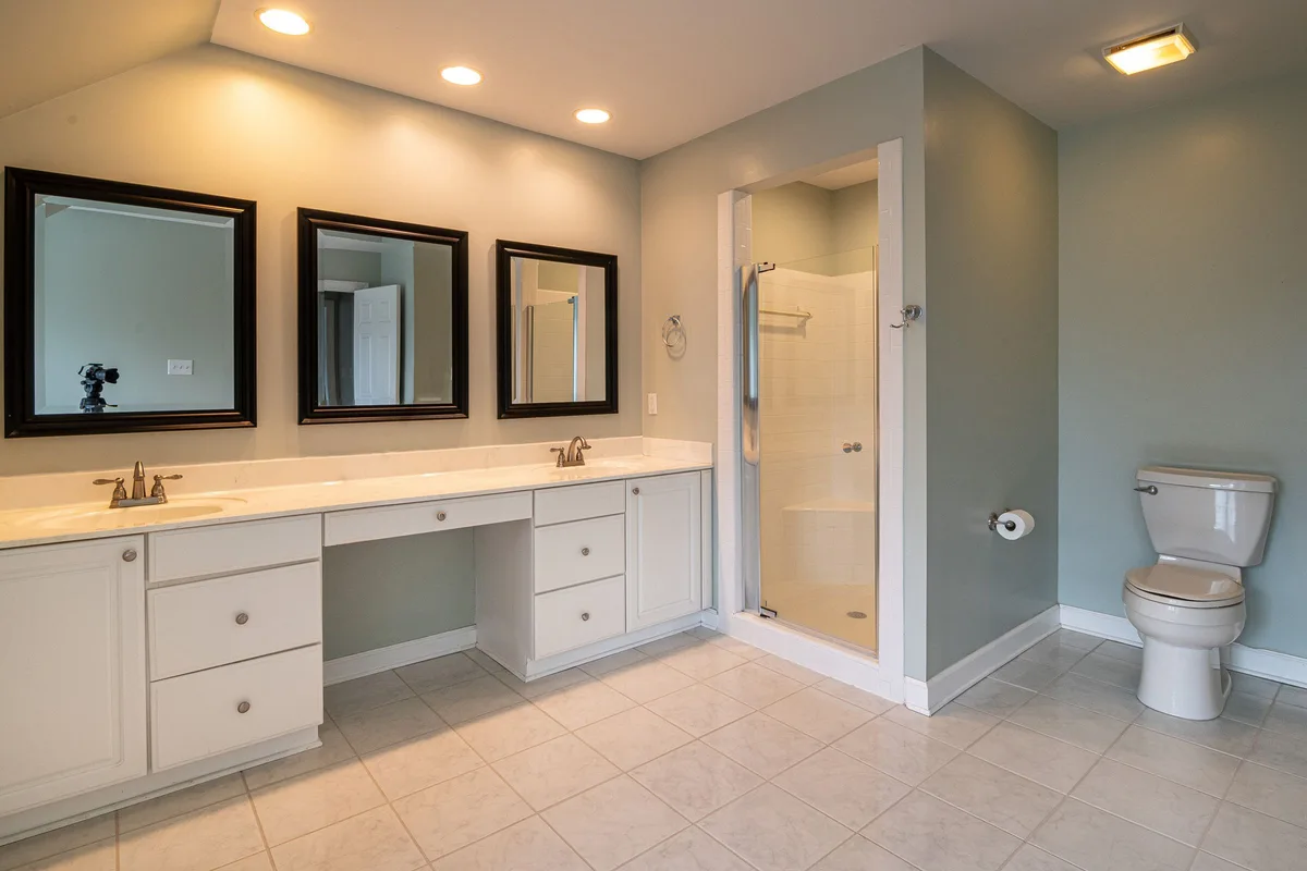 Remodeled bathroom with double vanity and walk-in shower