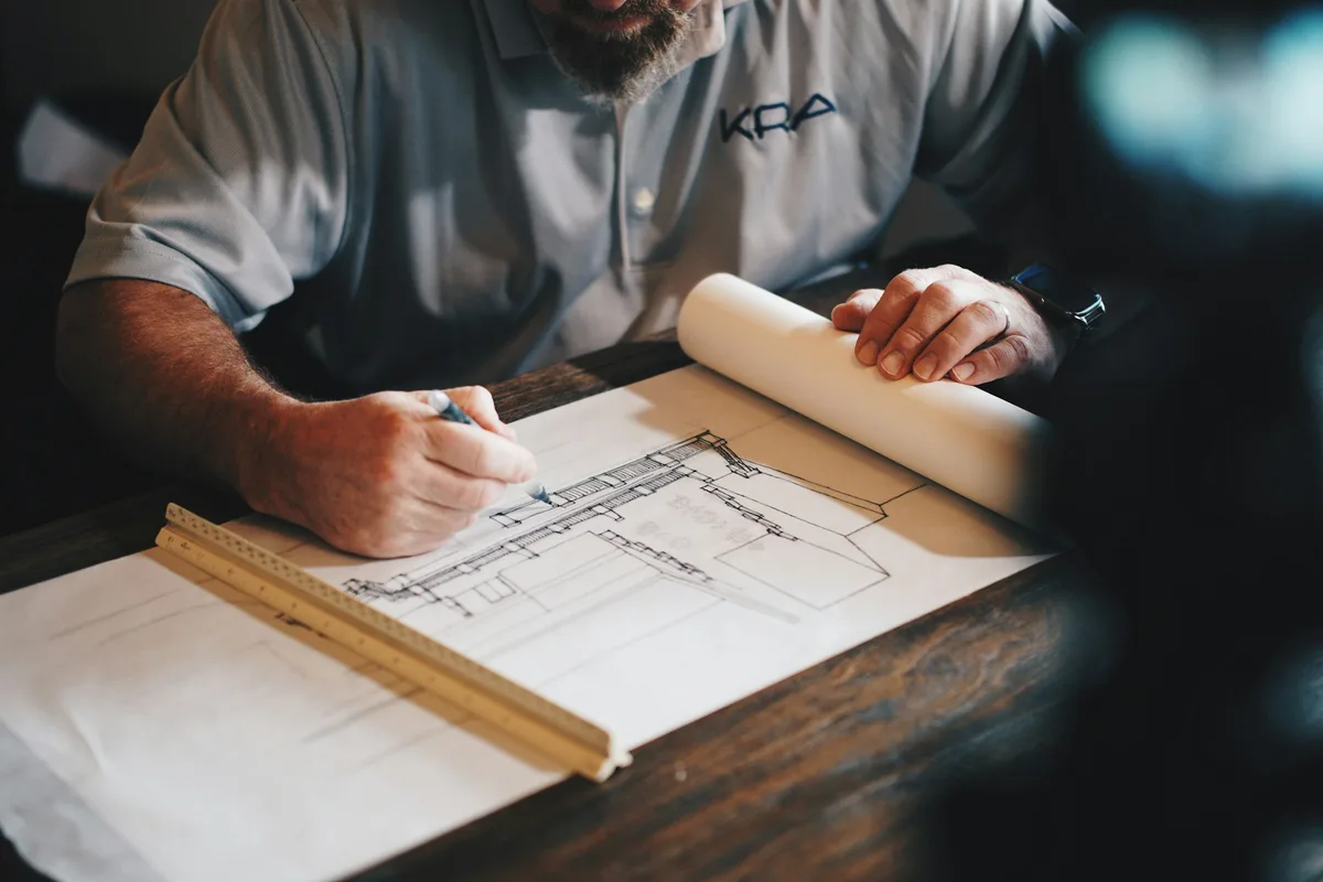 Contractor reviewing construction plans at a desk