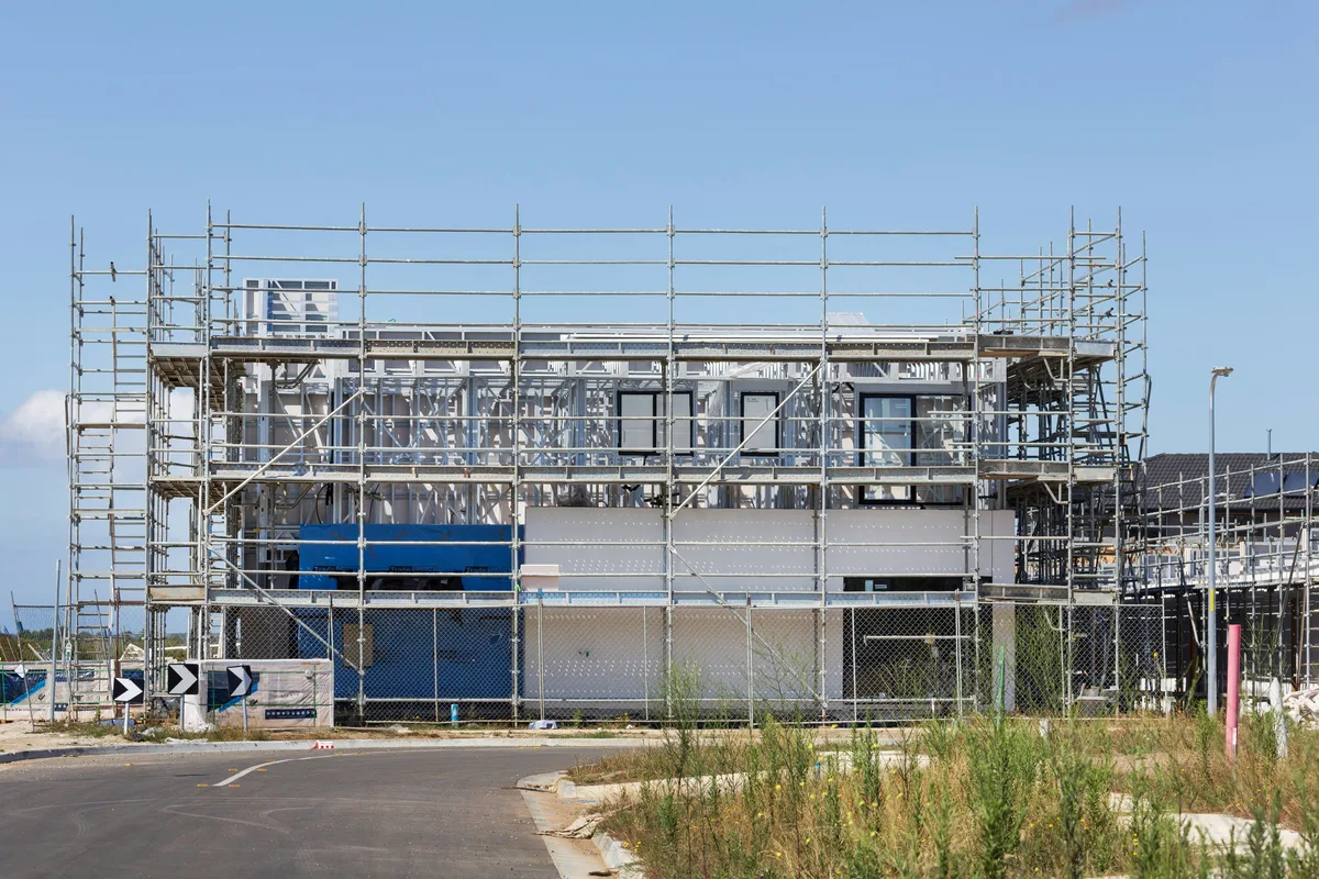 Multi-story building under construction with scaffolding